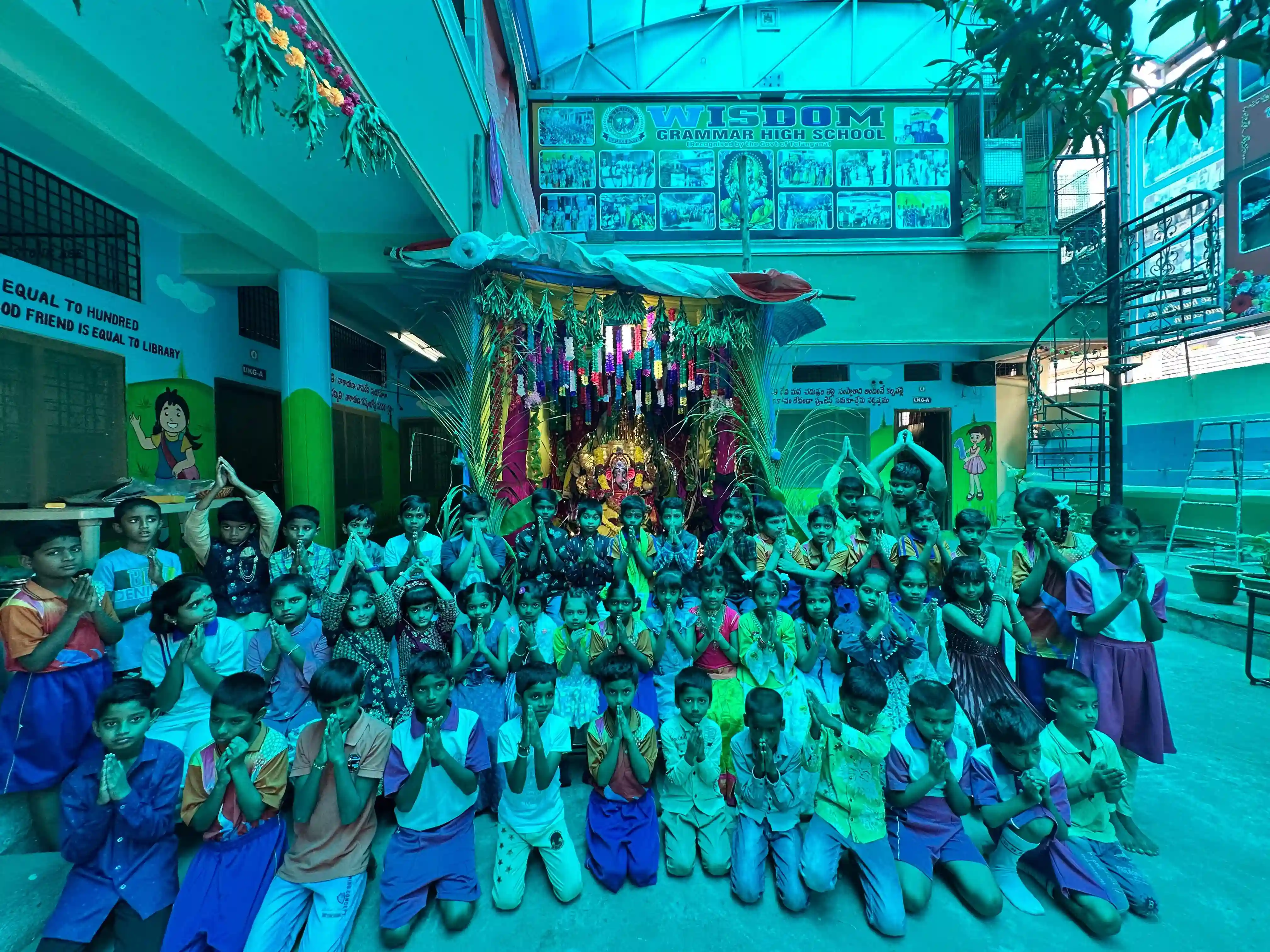 Students celebrating Ganesh Chavithi festival with decorations and traditional attire